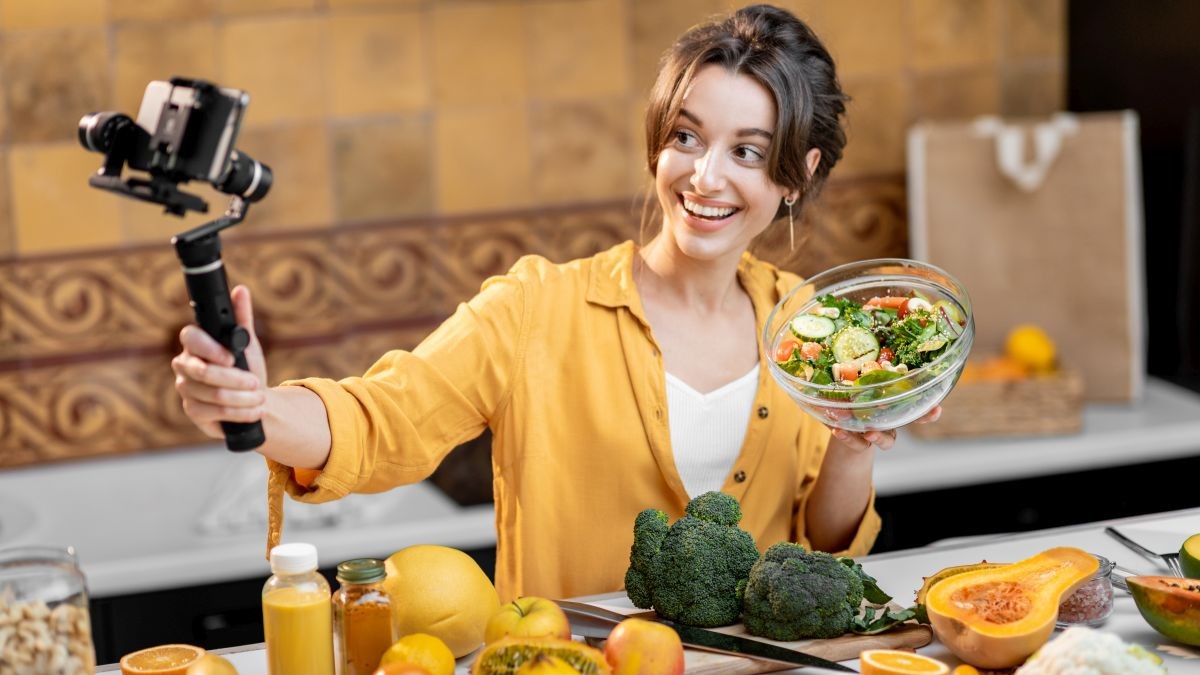Woman filming herself preparing food.