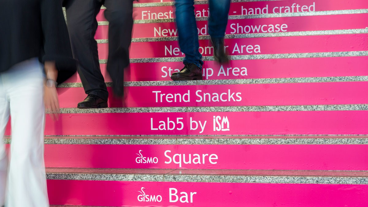 International Sweets & Biscuits Fair 2025: References to the highlights of ISM are displayed on the steps of Koelnmesse. Copyright: Koelnmesse