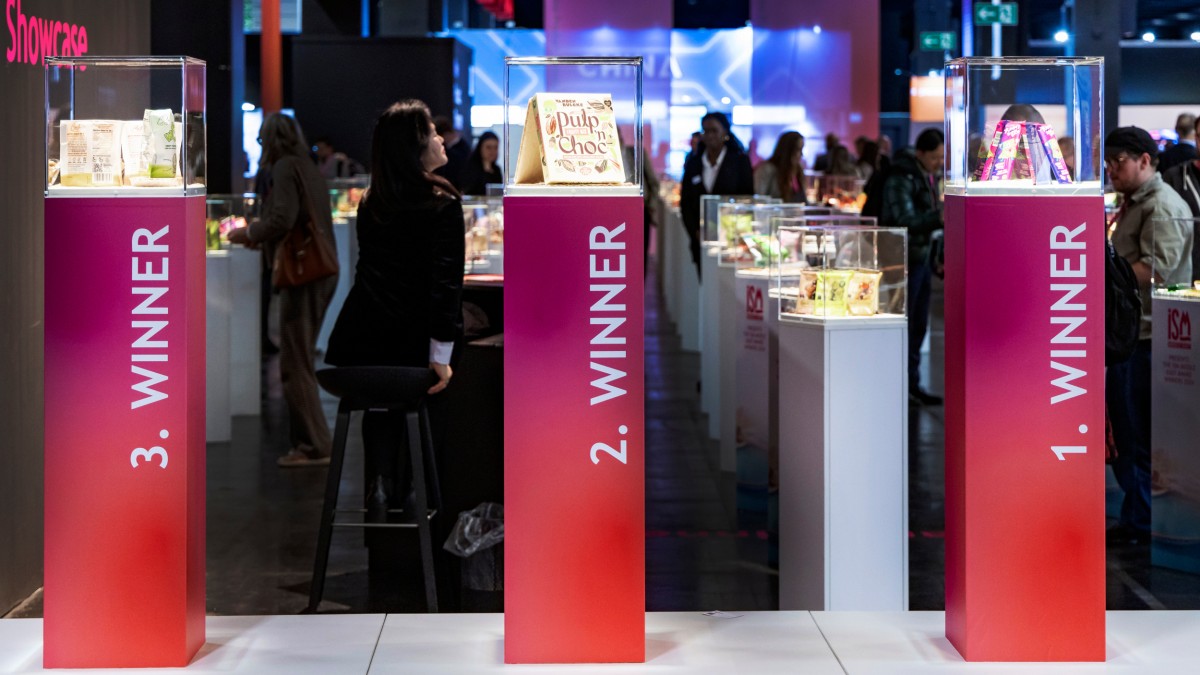 Visitors explore the ‘New Product Showcase’ exhibition at ISM, where innovative products are presented in illuminated showcases.