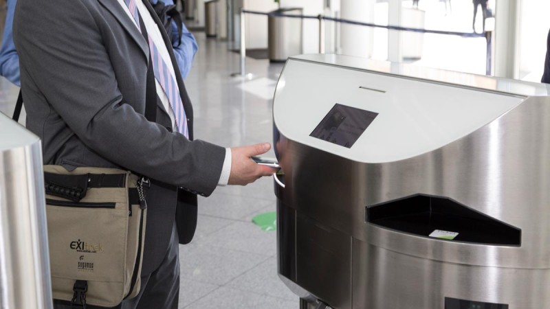 Person uses a mobile ticket on the smartphone to enter the exhibition grounds through the turnstile